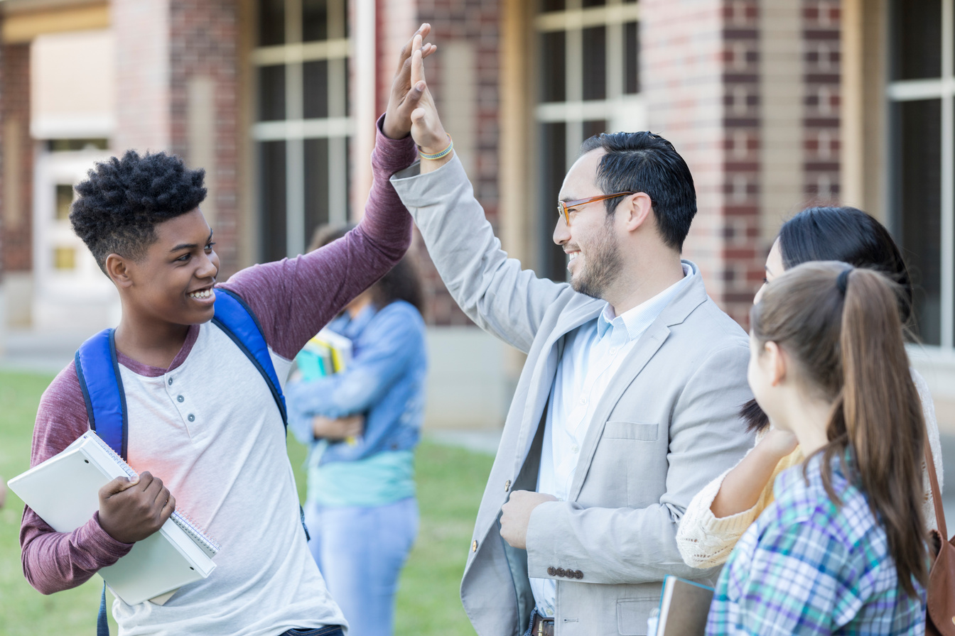 High school teacher gives student a high five