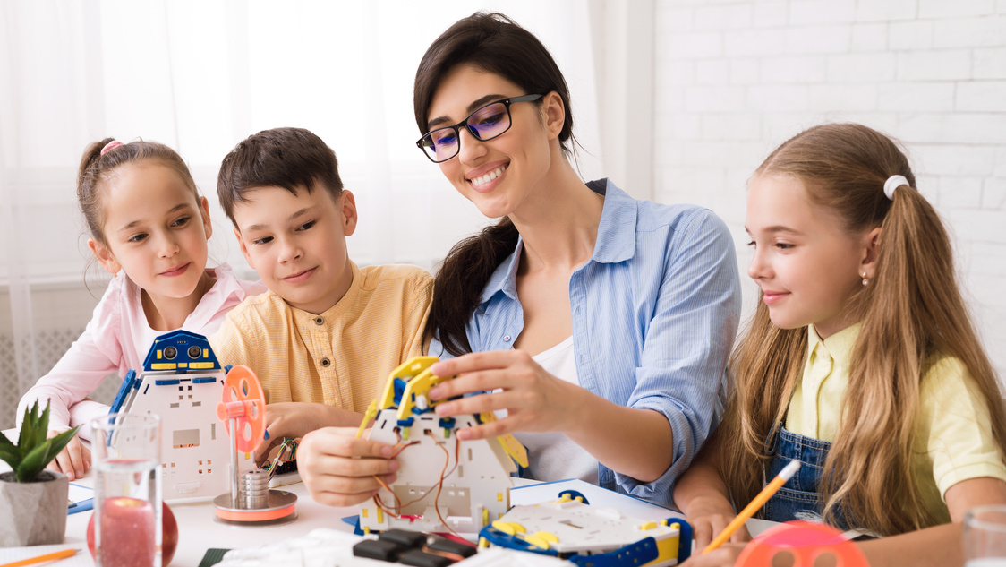 Stem education. Pupils creating robots with teacher